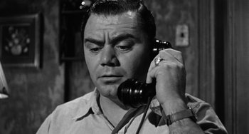 Movie still from “Marty” (1955), directed by Delbert Mann – A man holding a phone up to his ear; Close Up shot, Low angle