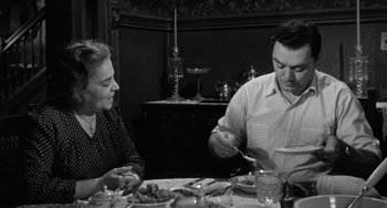 Movie still from “Marty” (1955), directed by Delbert Mann – An older man and woman sitting at a dinner table; Medium shot, High angle