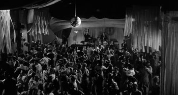 Movie still from “Marty” (1955), directed by Delbert Mann – A crowd of people in a room with a disco ball; Extreme Wide shot, High angle