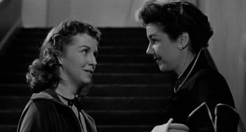 Movie still from “Marty” (1955), directed by Delbert Mann – Two women talking to each other in front of a staircase; Close Up shot, Low angle