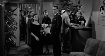 Movie still from “Marty” (1955), directed by Delbert Mann – A black and white photo of a group of people standing around; Wide shot, High angle