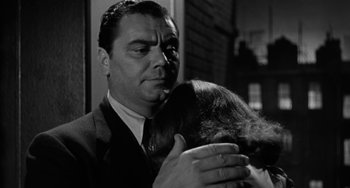 Movie still from “Marty” (1955), directed by Delbert Mann – A black and white photo of a man holding a woman; Close Up shot, Low angle