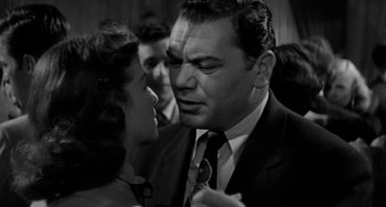 Movie still from “Marty” (1955), directed by Delbert Mann – An old photo of a man and a woman; Close Up shot, Low angle