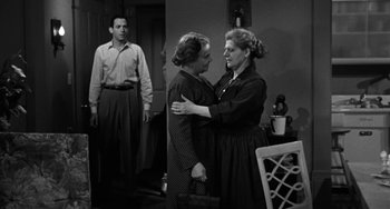 Movie still from “Marty” (1955), directed by Delbert Mann – Two women and a man in a room with a table and a chair; Medium shot, High angle