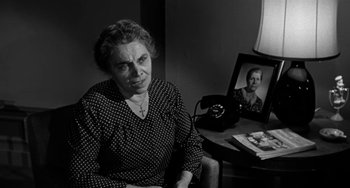 Movie still from “Marty” (1955), directed by Delbert Mann – An older woman sitting in front of a picture of herself; Medium shot, High angle