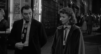 Movie still from “Marty” (1955), directed by Delbert Mann – A man and a woman standing next to each other on the sidewalk; Medium shot, Low angle