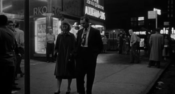 Movie still from “Marty” (1955), directed by Delbert Mann – A man and a woman walking down a street; Wide shot, High angle