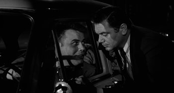 Movie still from “Marty” (1955), directed by Delbert Mann – A black and white photo of a man looking in a mirror; Close Up shot, Over the shoulder angle