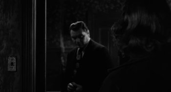 Movie still from “Marty” (1955), directed by Delbert Mann – A black and white photo of a man in a suit and tie; Close Up shot, Over the shoulder angle