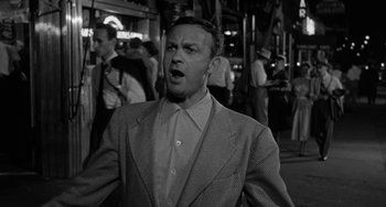 Movie still from “Marty” (1955), directed by Delbert Mann – An old photo of a man in a suit and tie; Close Up shot, Low angle