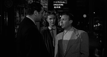 Movie still from “Marty” (1955), directed by Delbert Mann – A man and two women standing next to each other; Medium shot, Low angle