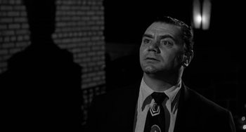 Movie still from “Marty” (1955), directed by Delbert Mann – Black and white photograph of a man in a suit and tie looking up; Close Up shot, Low angle