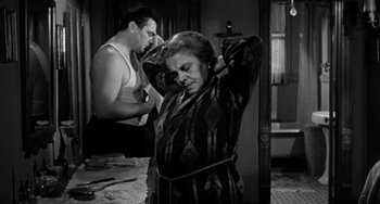 Movie still from “Marty” (1955), directed by Delbert Mann – An older woman tied up with a rope by a young man; Medium shot, Over the shoulder angle