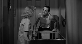 Movie still from “Marty” (1955), directed by Delbert Mann – A man and a woman are talking in a room; Medium shot, Over the shoulder angle