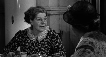Movie still from “Marty” (1955), directed by Delbert Mann – An older woman sitting at a table with another woman; Close Up shot, Over the shoulder angle
