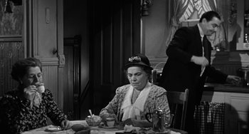 Movie still from “Marty” (1955), directed by Delbert Mann – An older woman sitting at a table with a bowl of food; Medium shot, Over the shoulder angle