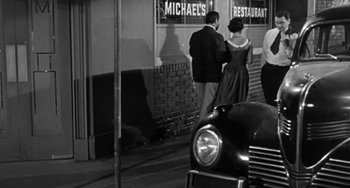 Movie still from “Marty” (1955), directed by Delbert Mann – A couple of people standing next to each other; Medium shot, High angle