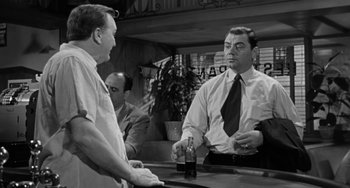 Movie still from “Marty” (1955), directed by Delbert Mann – Two men are talking to each other at a bar; Medium shot, Over the shoulder angle