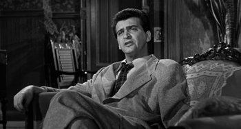Movie still from “Marty” (1955), directed by Delbert Mann – A black and white photo of a man sitting in a chair; Medium shot, Low angle