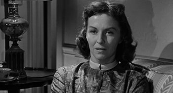 Movie still from “Marty” (1955), directed by Delbert Mann – An old photo of an older woman in a dress; Close Up shot, Over the shoulder angle