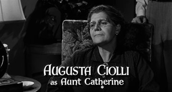 Movie still from “Marty” (1955), directed by Delbert Mann – An older woman sitting in a chair in front of a tree; Medium shot, Over the shoulder angle