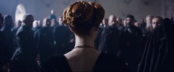 Movie still from “Mary Queen of Scots” (2018), directed by Josie Rourke – A person with a bun on their head; Close Up shot, Over the shoulder angle
