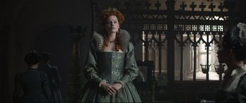 Movie still from “Mary Queen of Scots” (2018), directed by Josie Rourke – A woman in a green dress and a crown; Medium shot, Low angle