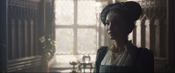 Movie still from “Mary Queen of Scots” (2018), directed by Josie Rourke – A woman in a medieval dress standing in front of a window; Close Up shot, Over the shoulder angle