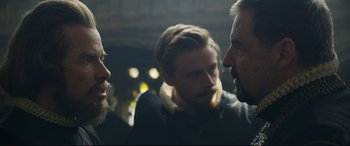 Movie still from “Mary Queen of Scots” (2018), directed by Josie Rourke – A group of men standing next to each other in a room; Close Up shot, Over the shoulder angle