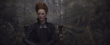 Movie still from “Mary Queen of Scots” (2018), directed by Josie Rourke – A woman sitting on a chair wearing a wig; Close Up shot, Over the shoulder angle