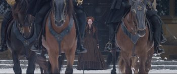 Movie still from “Mary Queen of Scots” (2018), directed by Josie Rourke – A woman in a brown dress standing in front of horses; Wide shot, Over the shoulder angle