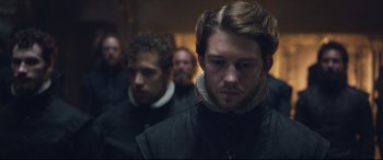 Movie still from “Mary Queen of Scots” (2018), directed by Josie Rourke – A man with a beard is looking at the camera; Close Up shot, Over the shoulder angle