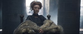 Movie still from “Mary Queen of Scots” (2018), directed by Josie Rourke – A woman sitting in a chair wearing a fur coat; Medium shot, Low angle
