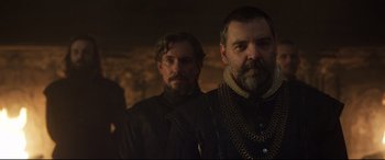 Movie still from “Mary Queen of Scots” (2018), directed by Josie Rourke – Two men standing next to each other in the dark; Medium shot, Over the shoulder angle