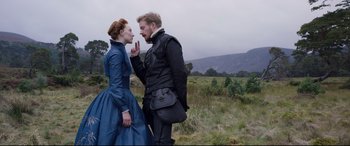Movie still from “Mary Queen of Scots” (2018), directed by Josie Rourke – A man and a woman standing next to each other in a field; Medium shot, Over the shoulder angle