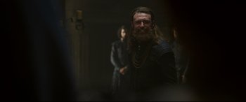 Movie still from “Mary Queen of Scots” (2018), directed by Josie Rourke – A man with long hair and a long beard; Medium shot, Over the shoulder angle