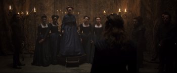 Movie still from “Mary Queen of Scots” (2018), directed by Josie Rourke – A group of women dressed in dark clothing; Wide shot, Low angle
