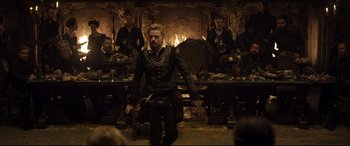 Movie still from “Mary Queen of Scots” (2018), directed by Josie Rourke – A group of men standing around a room; Wide shot, Over the shoulder angle