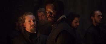Movie still from “Mary Queen of Scots” (2018), directed by Josie Rourke – A group of men standing in a dark room; Close Up shot, Over the shoulder angle