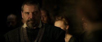 Movie still from “Mary Queen of Scots” (2018), directed by Josie Rourke – A person wearing a suit and tie; Close Up shot, Over the shoulder angle