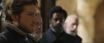 Movie still from “Mary Queen of Scots” (2018), directed by Josie Rourke – A group of men standing next to each other in a room; Close Up shot, Over the shoulder angle