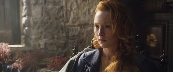 Movie still from “Mary Queen of Scots” (2018), directed by Josie Rourke – A woman with long red hair is looking into the distance; Close Up shot, Over the shoulder angle