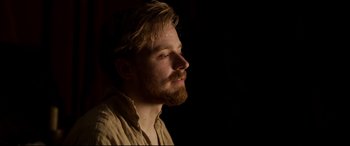 Movie still from “Mary Queen of Scots” (2018), directed by Josie Rourke – A man with a goatee is looking into the distance; Close Up shot, Over the shoulder angle