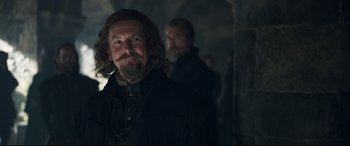 Movie still from “Mary Queen of Scots” (2018), directed by Josie Rourke – A man with long hair and a goatee standing next to another man with a beard; Close Up shot, Over the shoulder angle