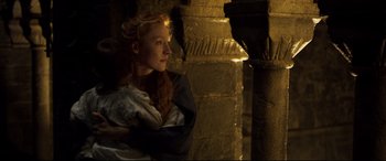 Movie still from “Mary Queen of Scots” (2018), directed by Josie Rourke – A woman standing next to a pillar in a dark room; Close Up shot, Low angle