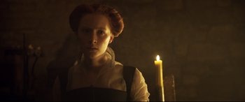 Movie still from “Mary Queen of Scots” (2018), directed by Josie Rourke – A woman with a candle in the dark; Close Up shot, Low angle