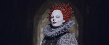 Movie still from “Mary Queen of Scots” (2018), directed by Josie Rourke – A woman with white makeup on her face and red hair; Close Up shot, Low angle