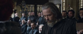 Movie still from “Mary Queen of Scots” (2018), directed by Josie Rourke – A group of people in a room with a man in a black robe; Close Up shot, Over the shoulder angle