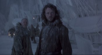 Movie still from “Frankenstein” (1994), directed by Kenneth Branagh – A man with a beard is standing in the snow; Medium shot, Low angle