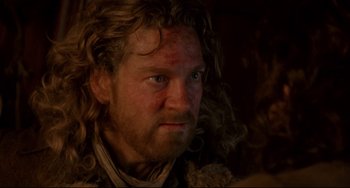 Movie still from “Frankenstein” (1994), directed by Kenneth Branagh – A person with long curly hair; Close Up shot, Over the shoulder angle